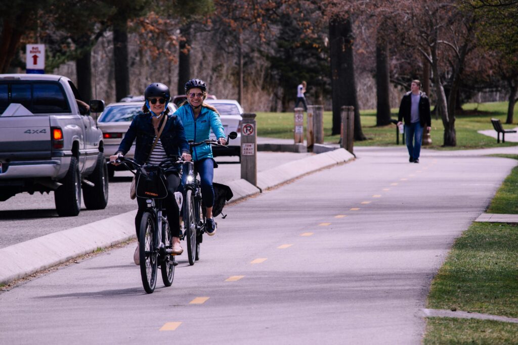 Two Girls are cycling on road