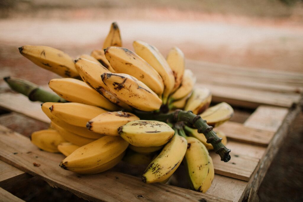 a bunch of bananas on a wooden surface