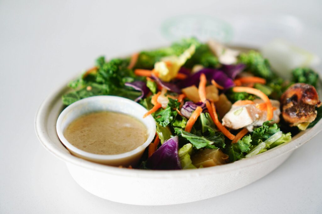 a bowl of salad with a sauce