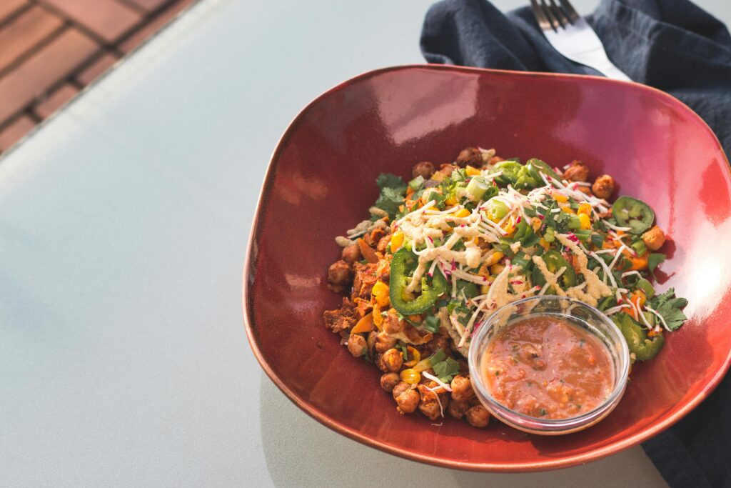 a bowl of food with a fork and knife