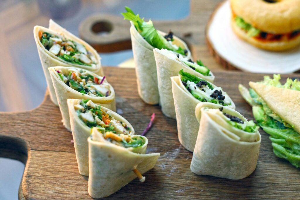 a group of tortilla wraps on a wood surface