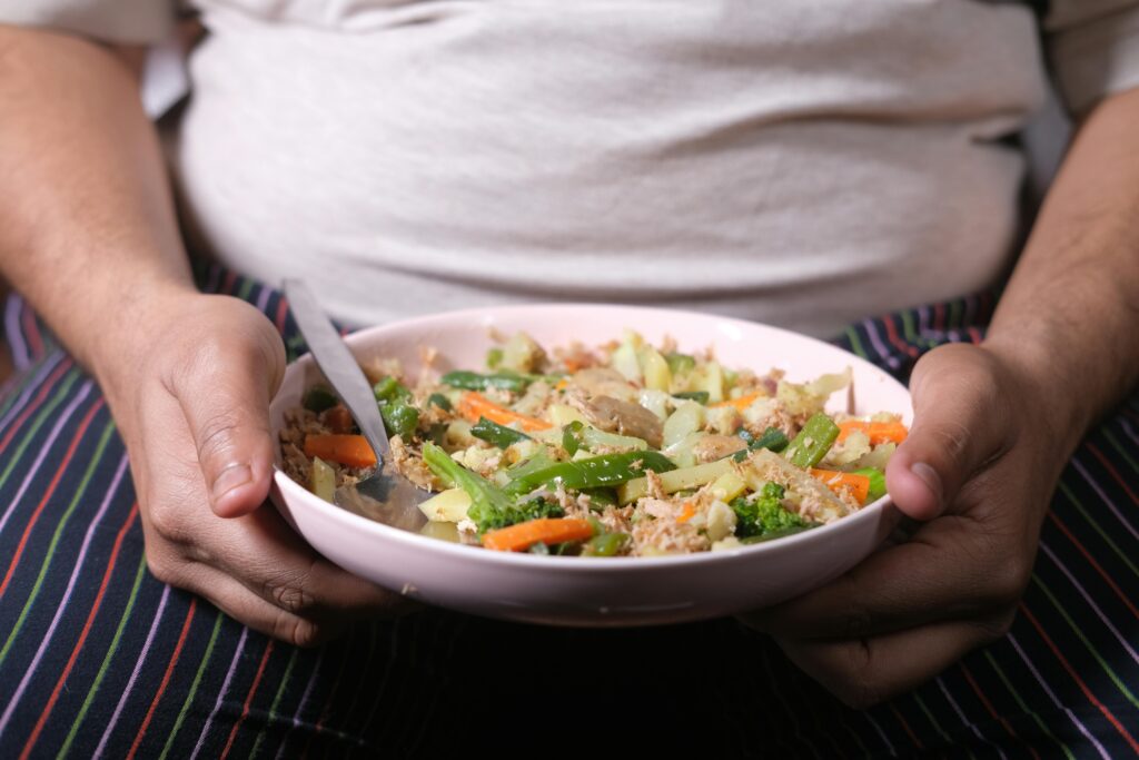 a person holding a bowl of food